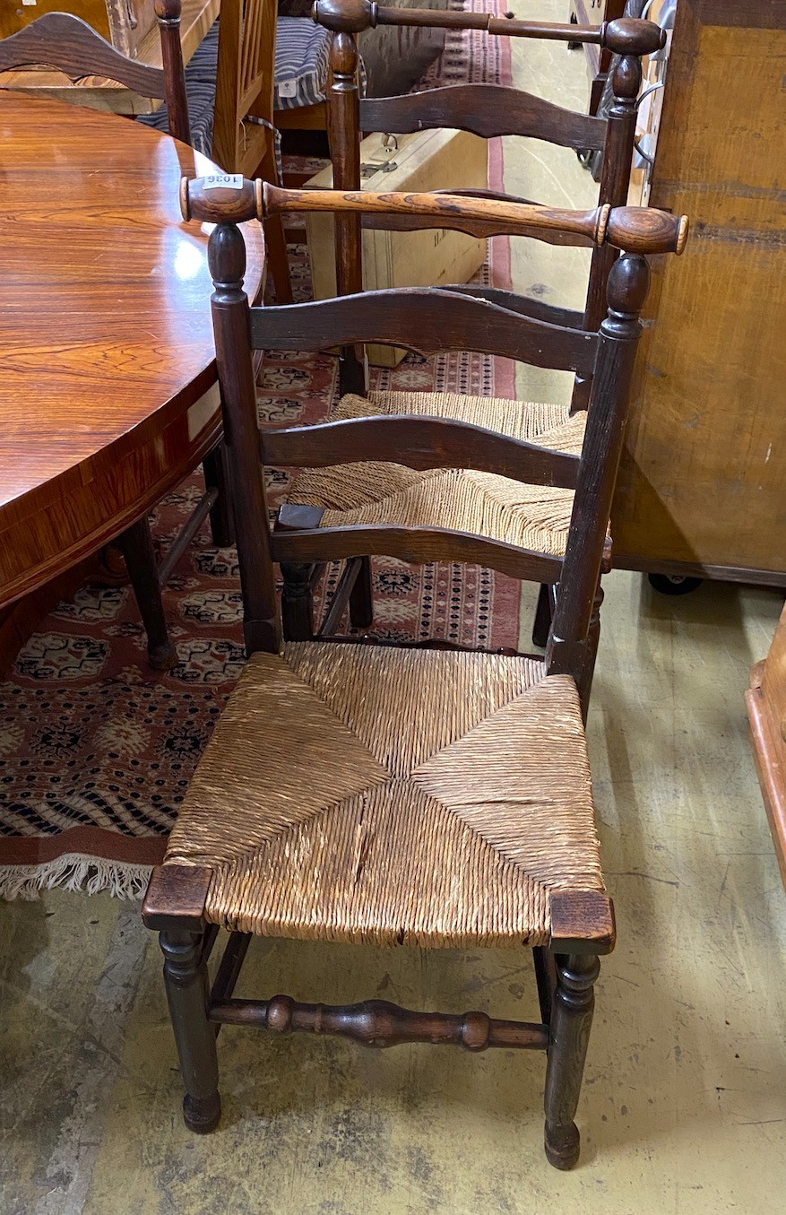 A set of six rush seated ladderback dining chairs